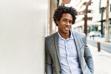 Young african american businessman smiling happy standing at the city.