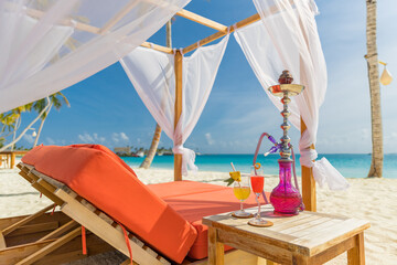 Cocktail glass hookah in tent, canopy on sea beach resort, idyllic summer recreational leisure...