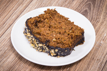 Pastry made of zucchini with nuts and raisin on plate. Delicious dessert