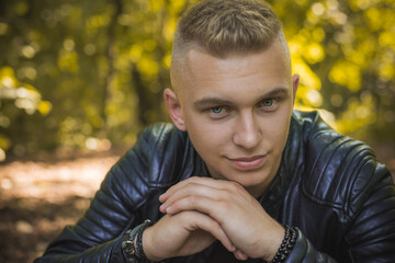 Smiling young handsome stylish student, blonde guy, lifestyle of teen- youth life. Portrait of young man