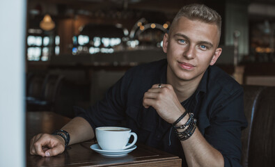 Smiling young handsome stylish student, blonde guy, lifestyle of teen- youth life. Portrait of young man
