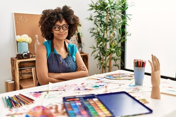 Beautiful african american woman with afro hair painting at art studio smiling looking to the side and staring away thinking.