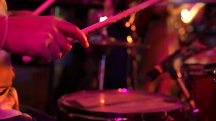 close up Professional drum player's hand plays electronic Drum with dynamic power in night club event.