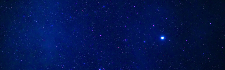 tellar Milky Way at night with stars. Panorama of the dark blue starry sky