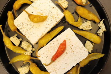 Baked feta cheese with pepperoni and onions