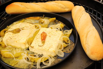 Baked feta cheese with pepperoni and onions