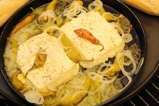 Baked feta cheese with pepperoni and onions