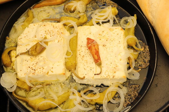 Baked feta cheese with pepperoni and onions