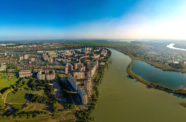 Aerial landscape city near the river - the outskirts of the city of Krasnodar (south of Russia) near the Kuban river and Starobzhegokai lake on a sunny summer day