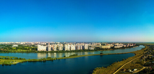 Landscape of the city by the river - the outskirts of the city of Krasnodar (South of Russia) near the Kuban River and Lake Starobzhegokai on a sunny summer day - obrazy, fototapety, plakaty