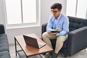 Young hispanic man psychologist having online session at psychology clinic