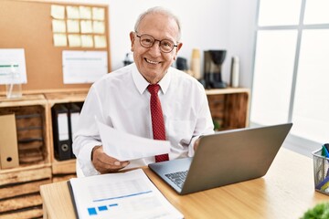 Senior man business worker reading document working at office