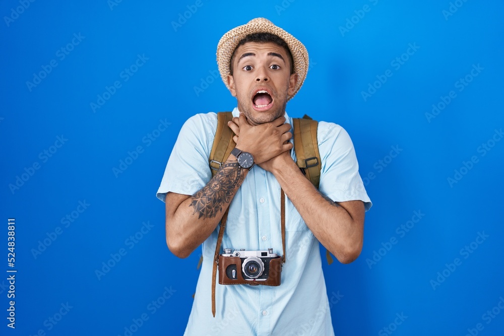 Sticker Brazilian young man holding vintage camera shouting and suffocate because painful strangle. health problem. asphyxiate and suicide concept.