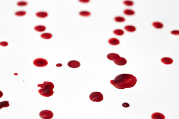 Drops of blood staining spots on a white background, medecine, drug addiction, killing