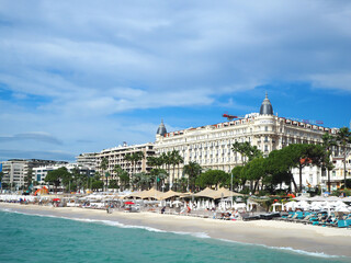 People sunbathing on a hot summer day on the beach along the Promenade de la Croisette is in Cannes, Cote d'Azur, France