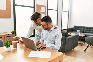 Two hispanic men business workers smiling confident working at office