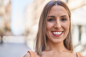 Young beautiful hispanic woman smiling confident standing at street