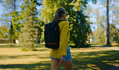 Woman tourist with backpack exploring forest.