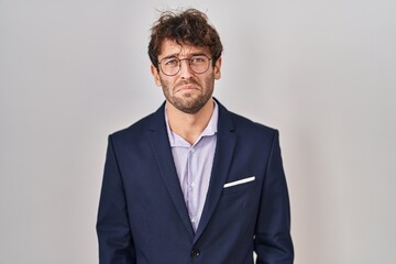 Hispanic business man wearing glasses depressed and worry for distress, crying angry and afraid. sad expression.