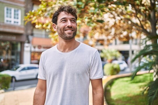 Young hispanic man smiling confident walking at park