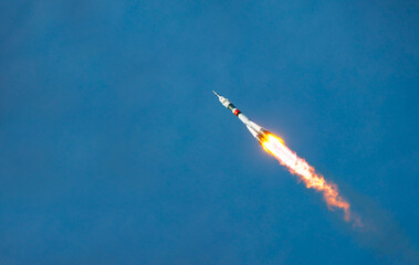 Take-off of a real launch vehicle from a spaceport. A rocket takes off into the sky against a background of clouds. Startup concept, power of science and technology.