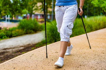 Nordic walking - woman training in city park
