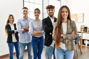 Fototapeta premium Group of young business workers smiling happy standing with arms crossed gesture at the office.