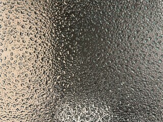 The golden light reflected on the glass with a crystal water drop pattern.