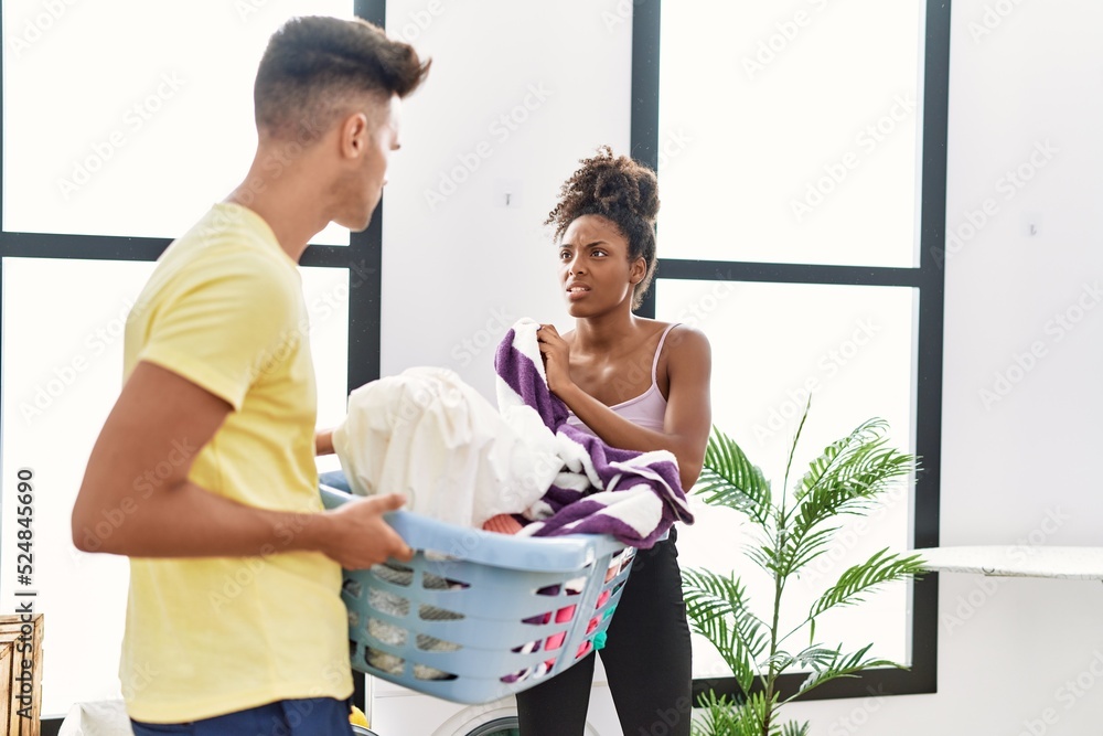 Canvas Prints man and woman couple arguing holding basket with clothes at laundry room