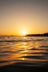 Sea and orange sky at sunset. Holiday landscape. Sun rays reflecting on the sea.  