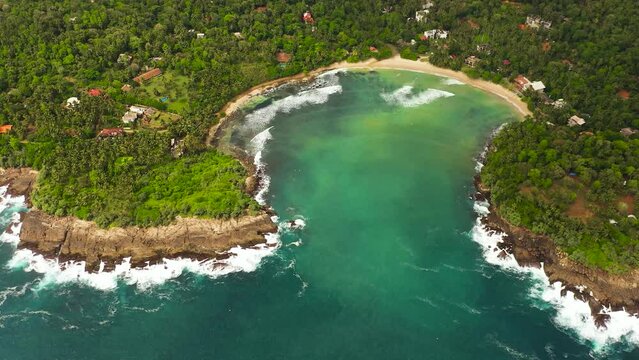 Aerial drone of beach in the bay, a place for surfing. Hiriketiya beach, Sri Lanka.