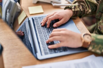 Young hispanic woman army soldier using laptop at office