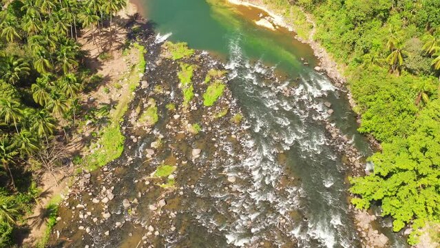 Aerial drone of river Cagayan de Oro flowing through the rainforest and jungle on the island of Mindanao, Philippines.