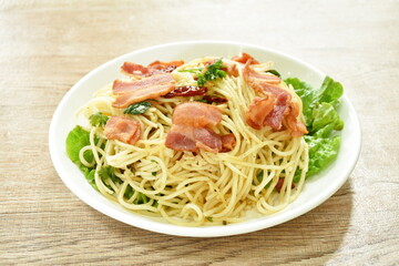 fried spaghetti topping crispy bacon and slice dry chili on plate  