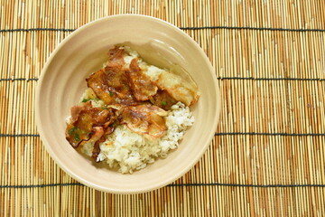 slice grilled salt pork with sauce topping Japanese rice on bowl