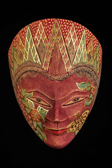 Traditional Indonesian face mask on a black background