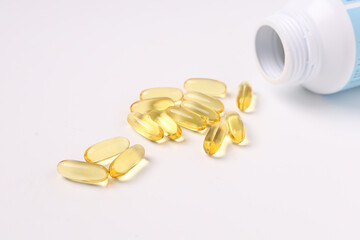fish oil capsules fish with omega 3 and vitamin D on white backgroud and supplements concept