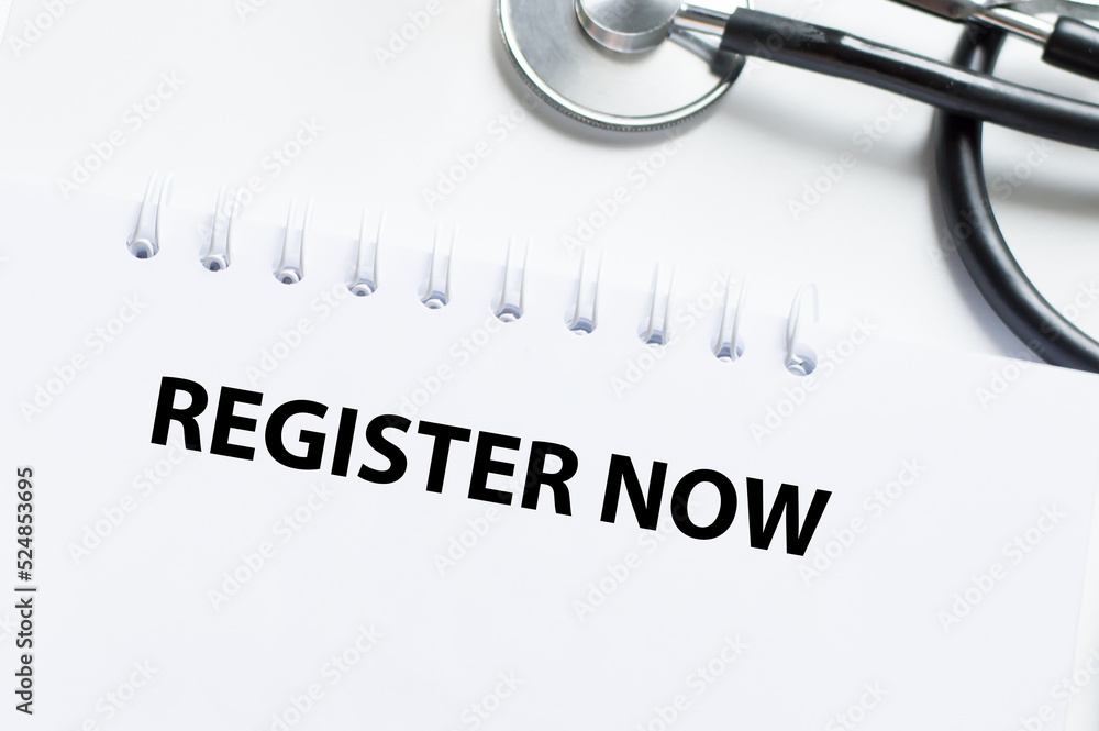 Poster REGISTER NOW text on notepad on a light table next to it is a stethoscope