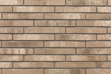 Decorative Relief Facing Plates Imitating beige Brick On The Wall. Textured brown brick background.