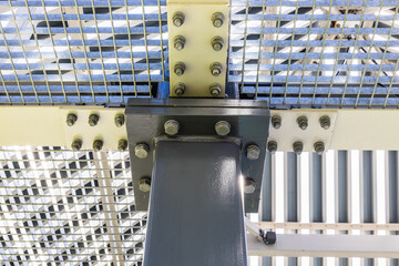 Part of a massive metal structure with bolts and rivets at the steel framework