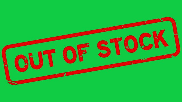 Grunge red out of stock word rubber stamp zoom on green background