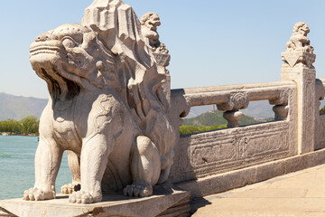 Fototapeta premium The stone beast at the end of the Seventeen-Arch Bridge in the Summer Palace, Beijing, China.