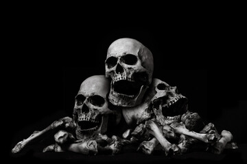 Awesome pile of skull human and bone on wooden, black cloth background, concept of scary crime scene of horror or thriller movies,Halloween theme, Still Life style, selective focus,