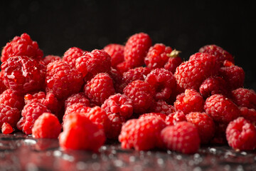Fresh raspberries on dark background. Close up. Selective focus. useful product