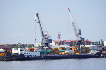 Cargo transportation. A cargo ship in the port of the city on the Volga River transports grain and timber. Russia