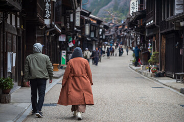 Rear of couple visit Narai-juku preserved historic post town