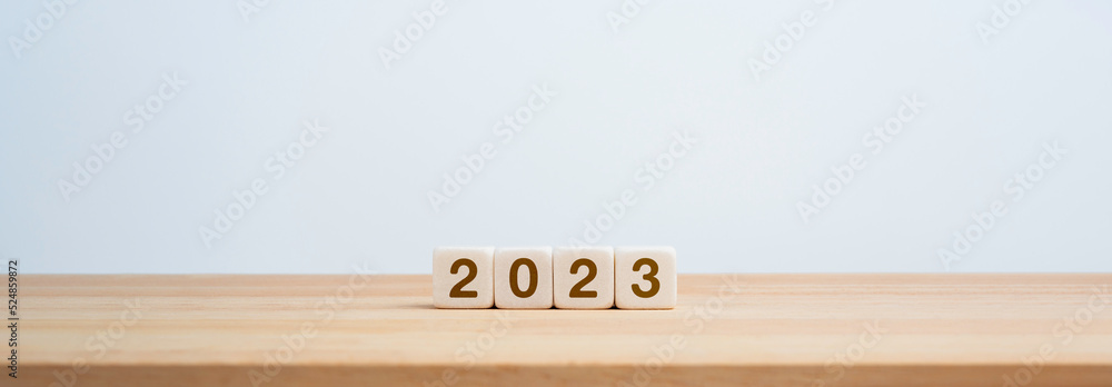 Aufkleber 2023 happy new year background banner. two thousand twenty-three year numbers on wooden cube blocks 