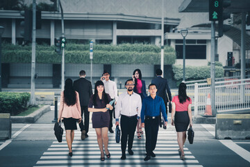 Crowded business people crossing the road