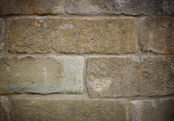 Old natural brown stone blocks wall. Textured background