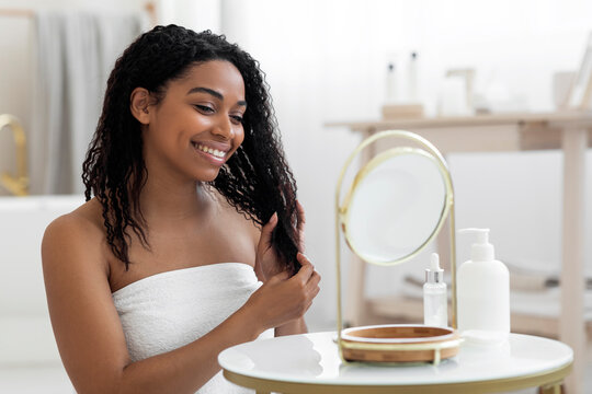 Beauty Care. Attractive Black Woman Wrapped In Towel Sitting At Dressing Table